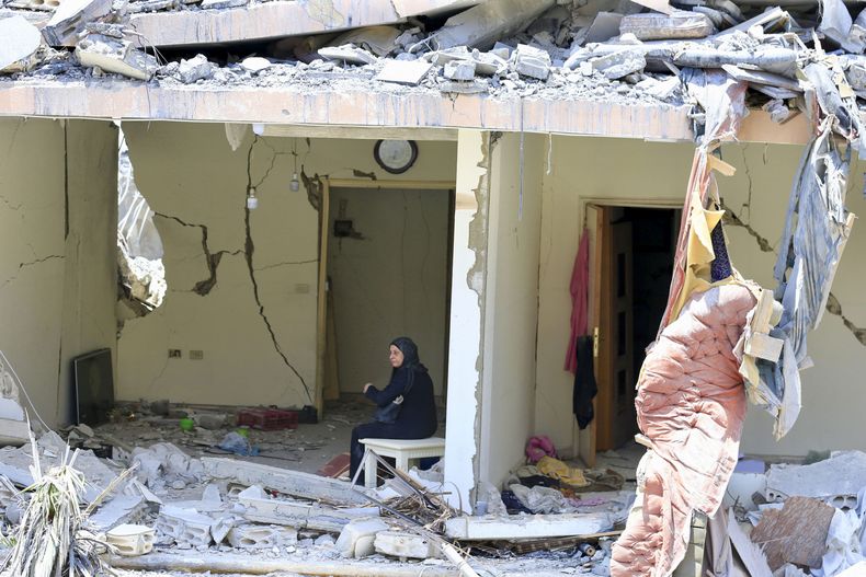 Photo taken on June 18, 2026 shows a woman sitting in a destroyed building after Israeli attacks in Nabatieh, southern Lebanon. (Photo by Ali Hashisho/Xinhua)